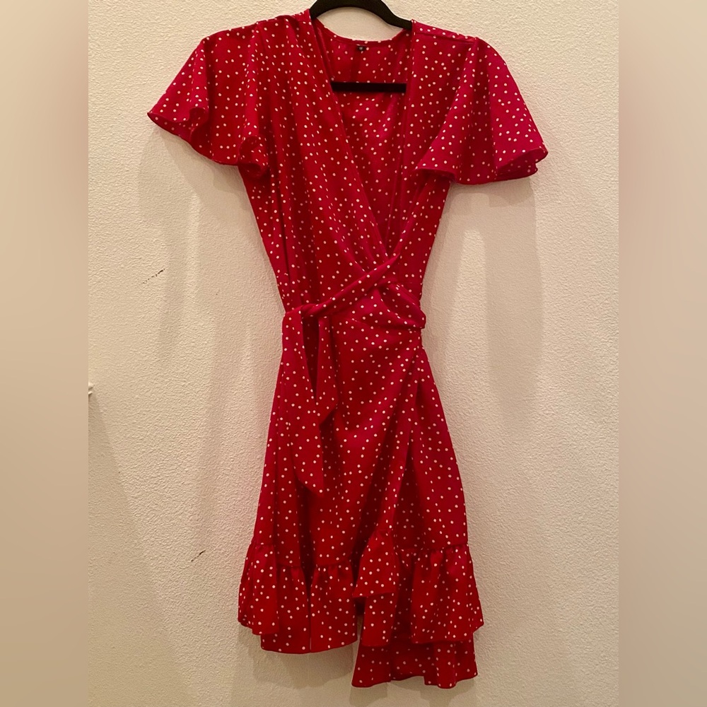 Red and white polka dot wrap dress with flutter sleeves.